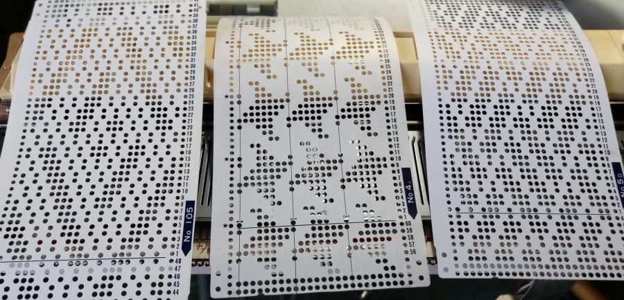 three knitting machine punchcards